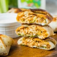 A stack of mini crunchwraps have been cut in half to reveal perfectly cooked centers.