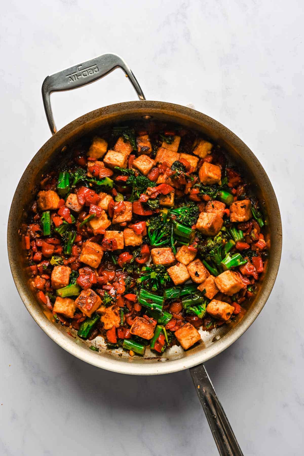 Spicy chili tofu stir fry in a large metal skillet.