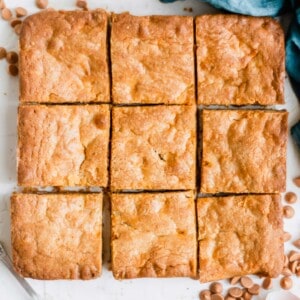 A blondie brownie sliced into nine even pieces.
