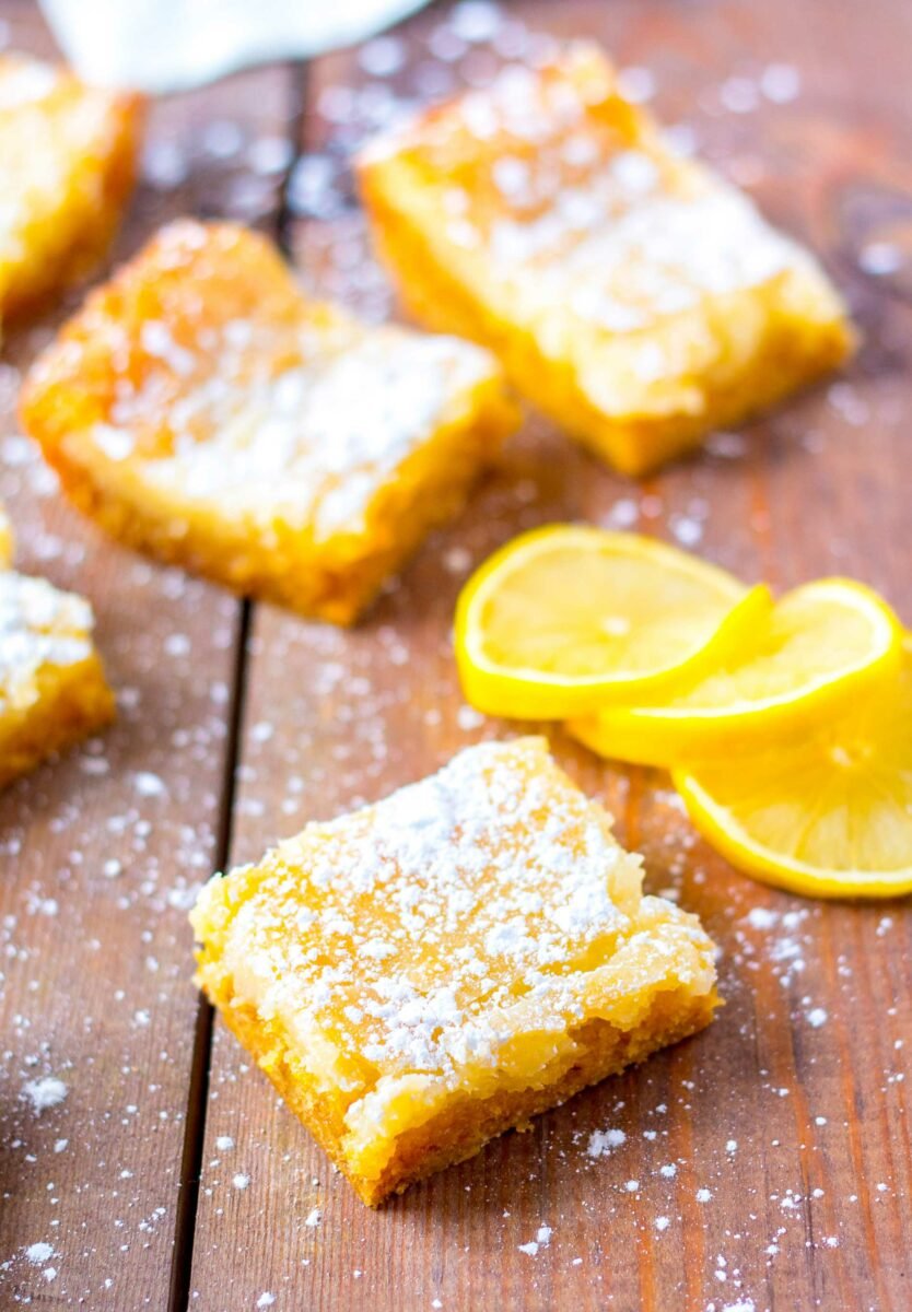 Pieces of buttery lemon cake are sprinkled with powdered sugar. 