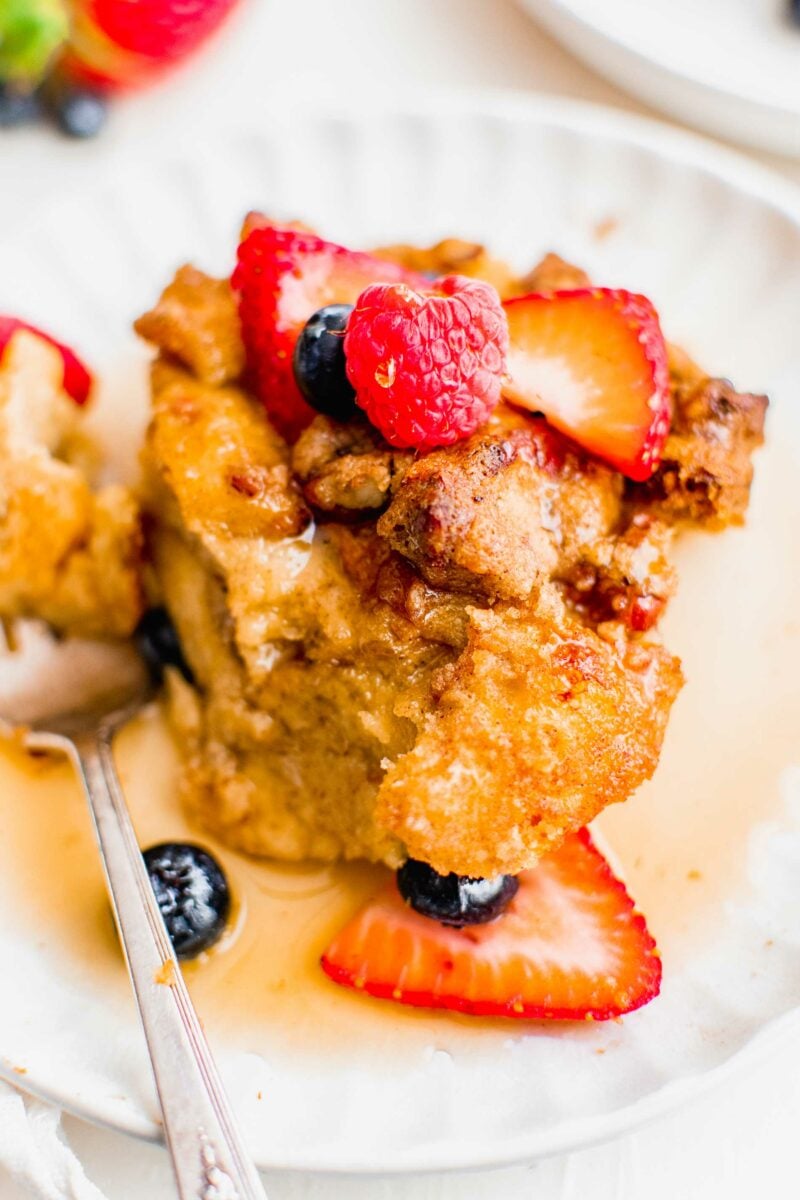 Berries sit atop a serving of breakfast casserole. 