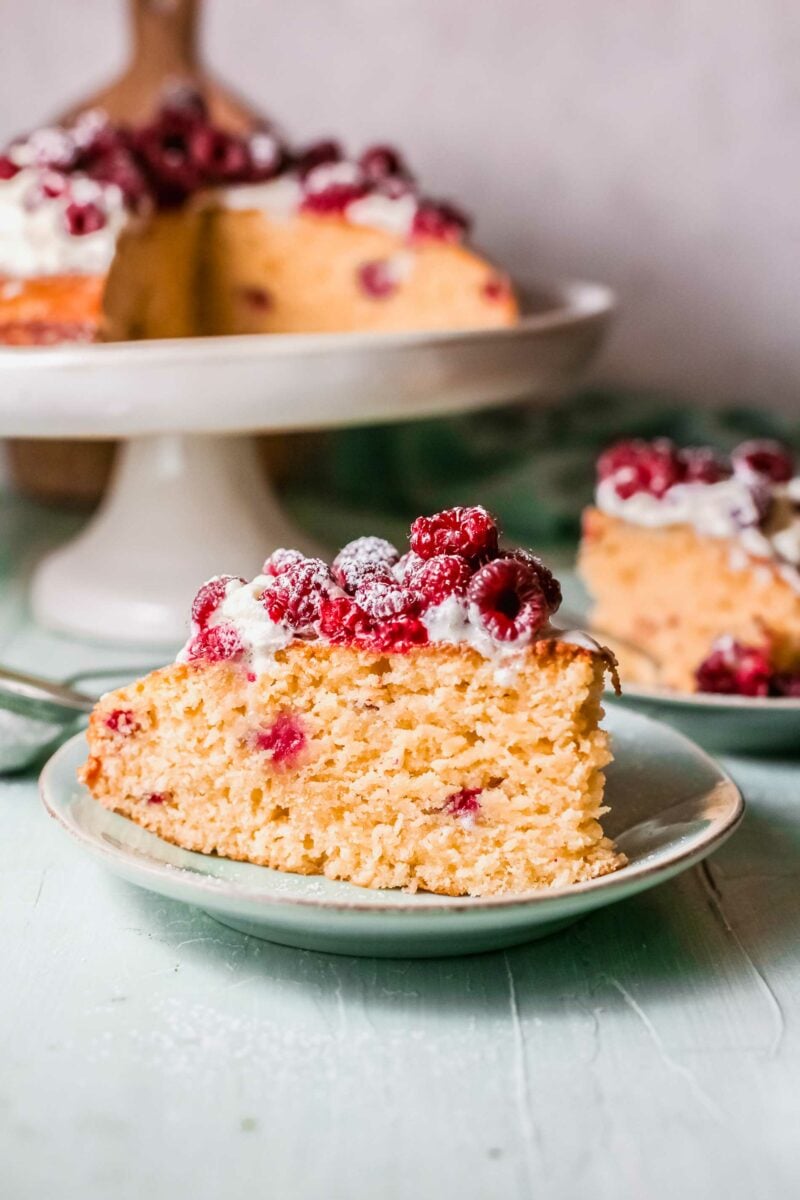 A piece of cake is topped with fresh berries. 