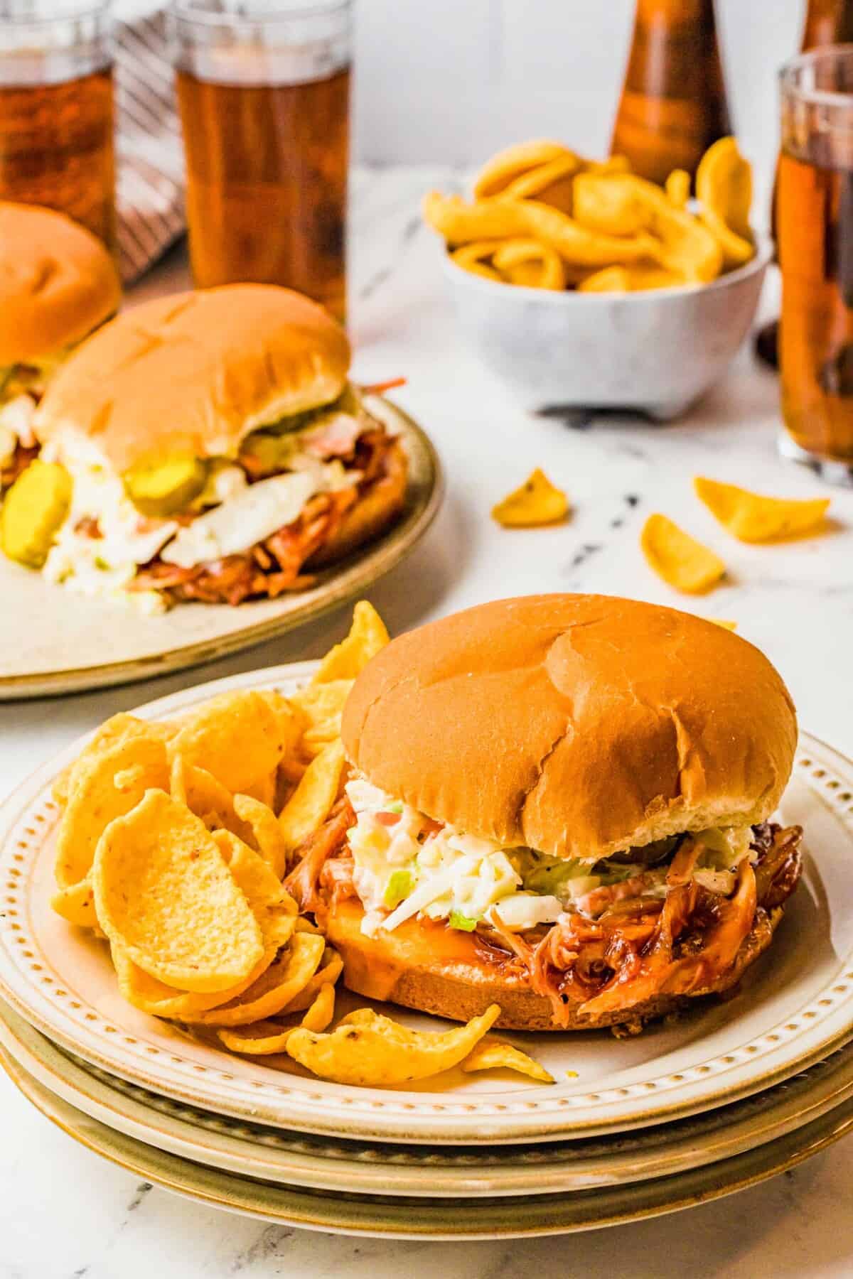 Chips, sandwiches and teas are all placed on a white marble countertop.