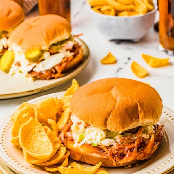 Chips, sandwiches and teas are all placed on a white marble countertop.