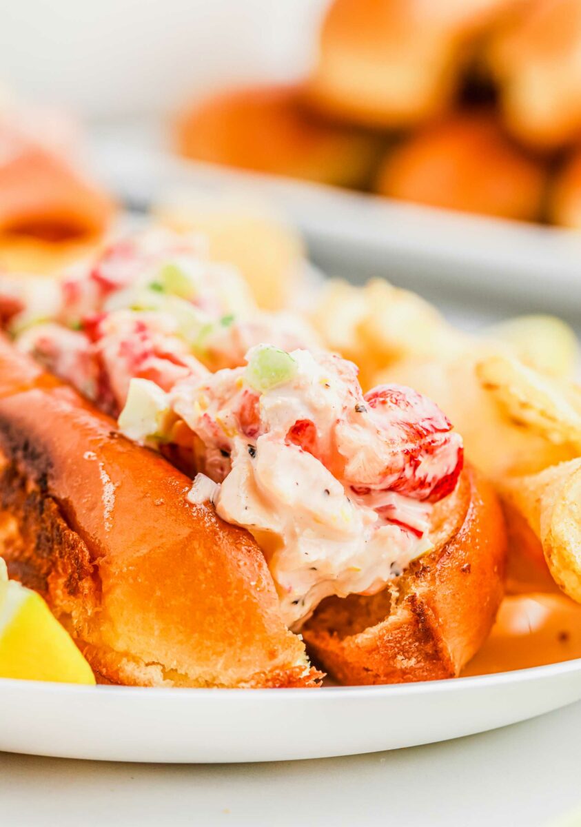Lobster and mayonnaise mixture fill a brioche hot dog bun.