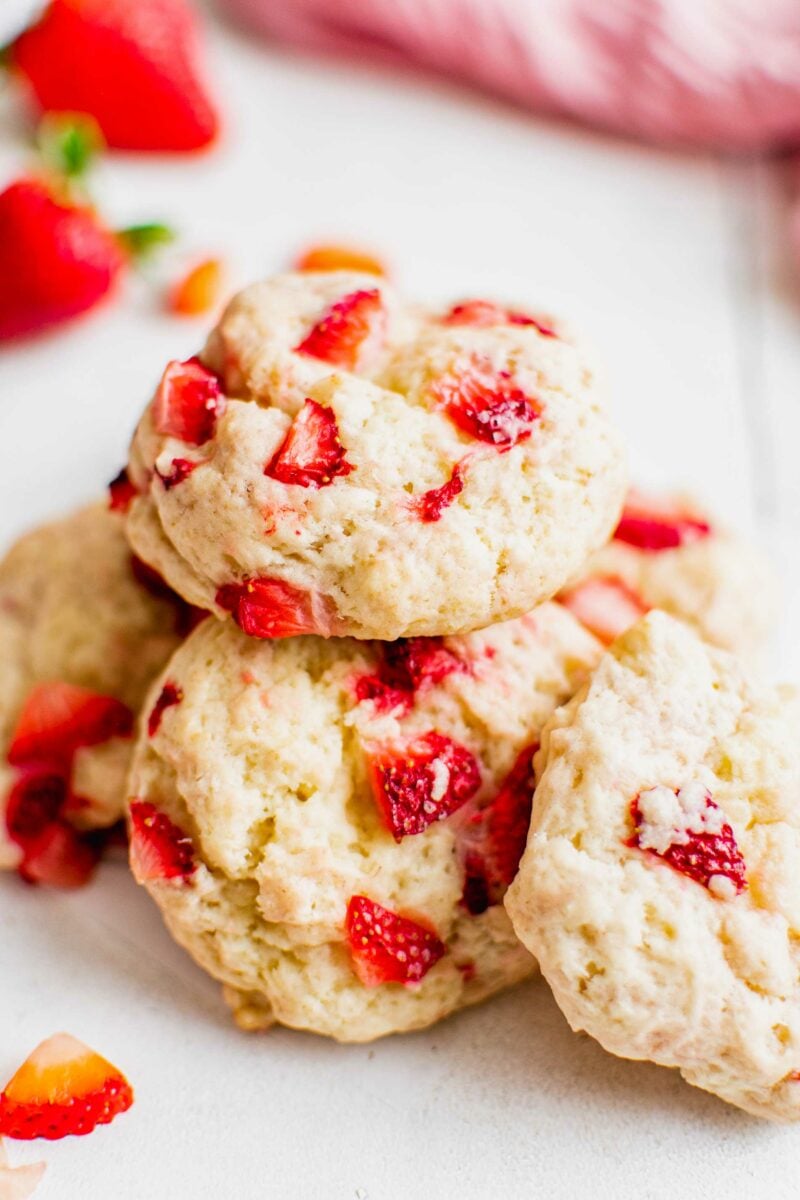 Cookies are stacked on top of each other on a white surface. 