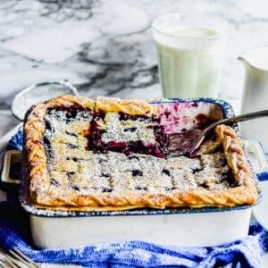 A spatula is lifting a piece of pie from the baking dish.