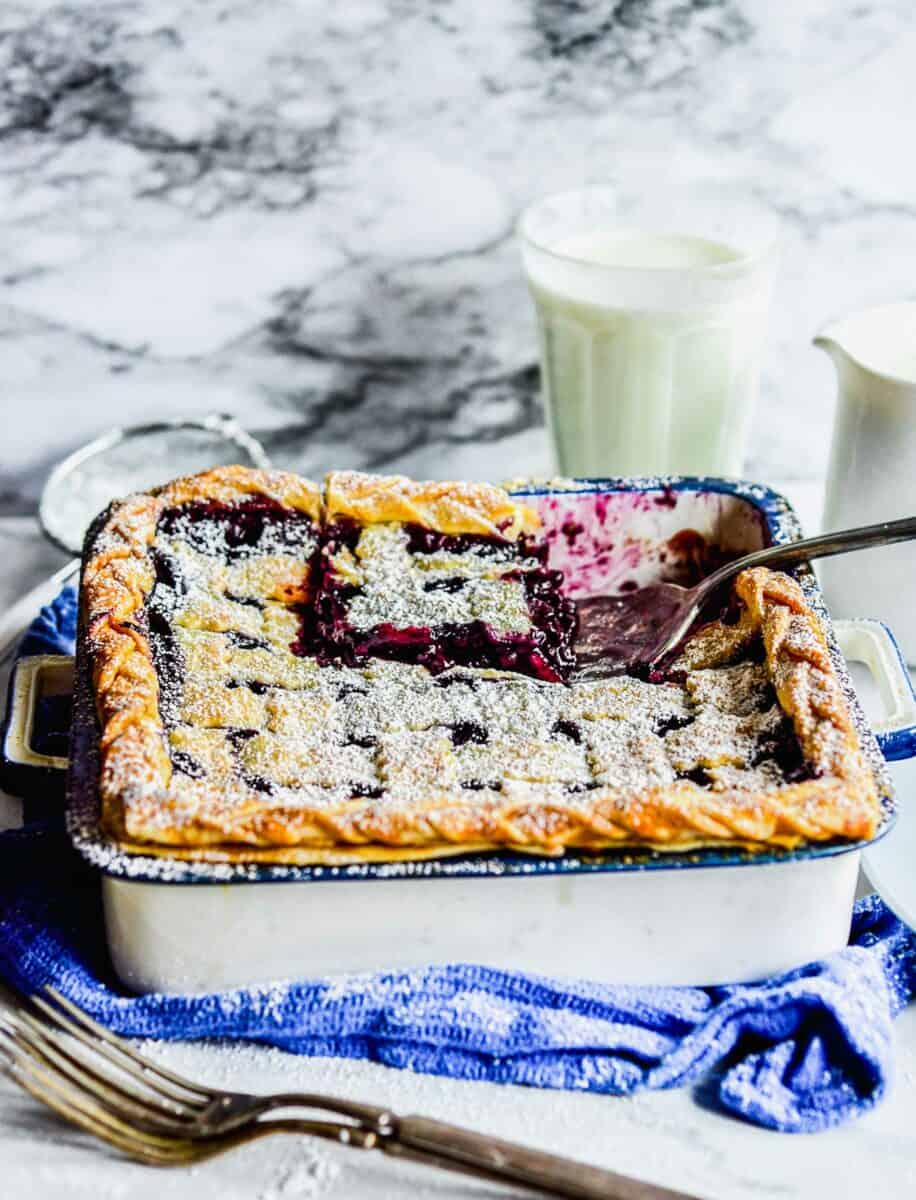 A spatula is lifting a piece of pie from the baking dish.