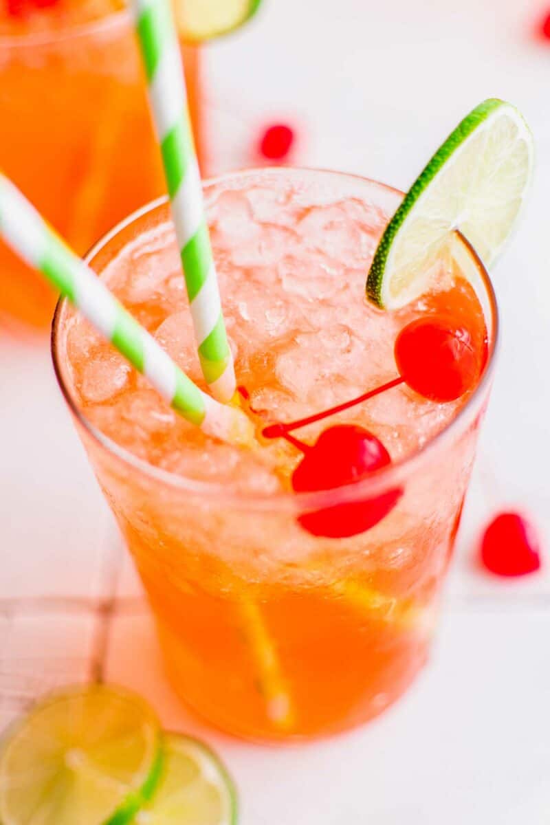 Two straws are placed in an icy glass of diet soda. 