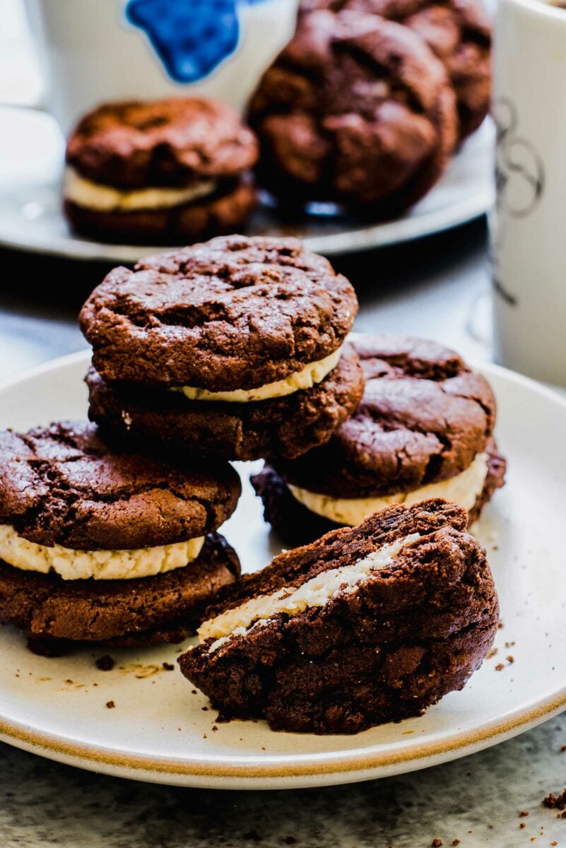 Multiple ice cream sandwiches are on a white plate. 