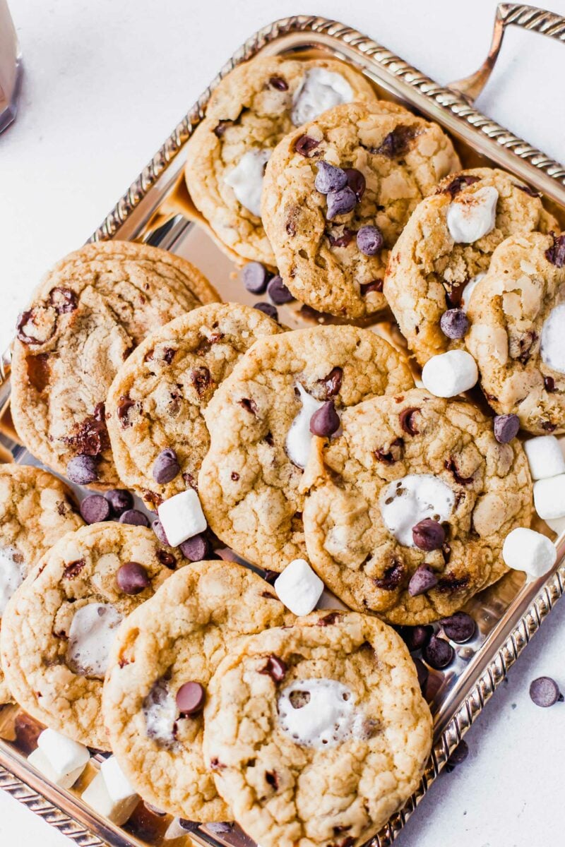 A metal platter is holding a batch of s'mores cookies. 