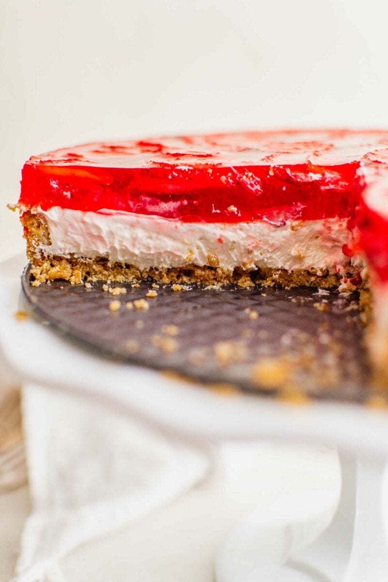 A strawberry pretzel salad has been sliced into. 