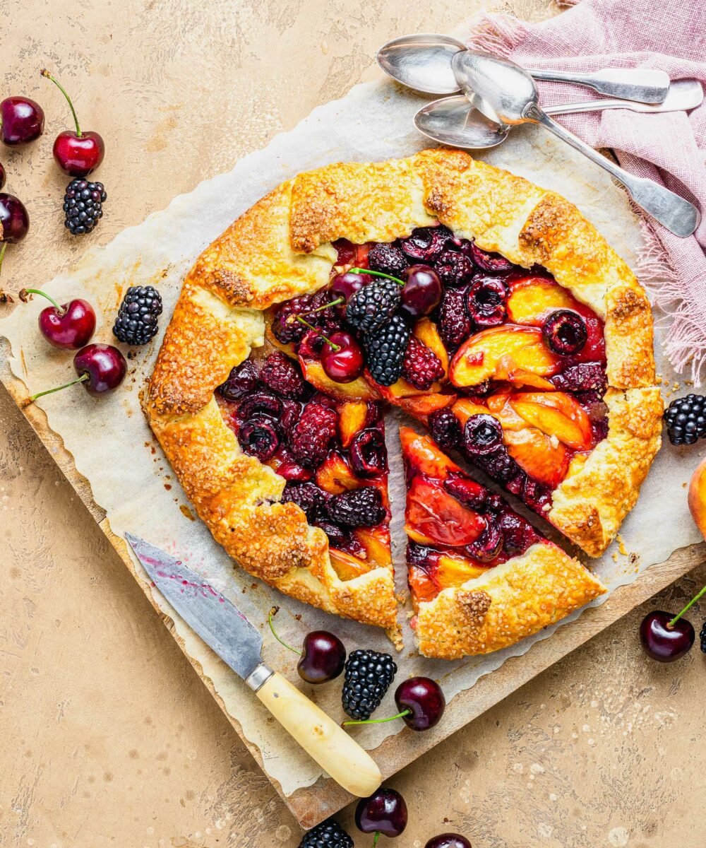 A slice of fruity galette has been cut from the rest of the dessert. 