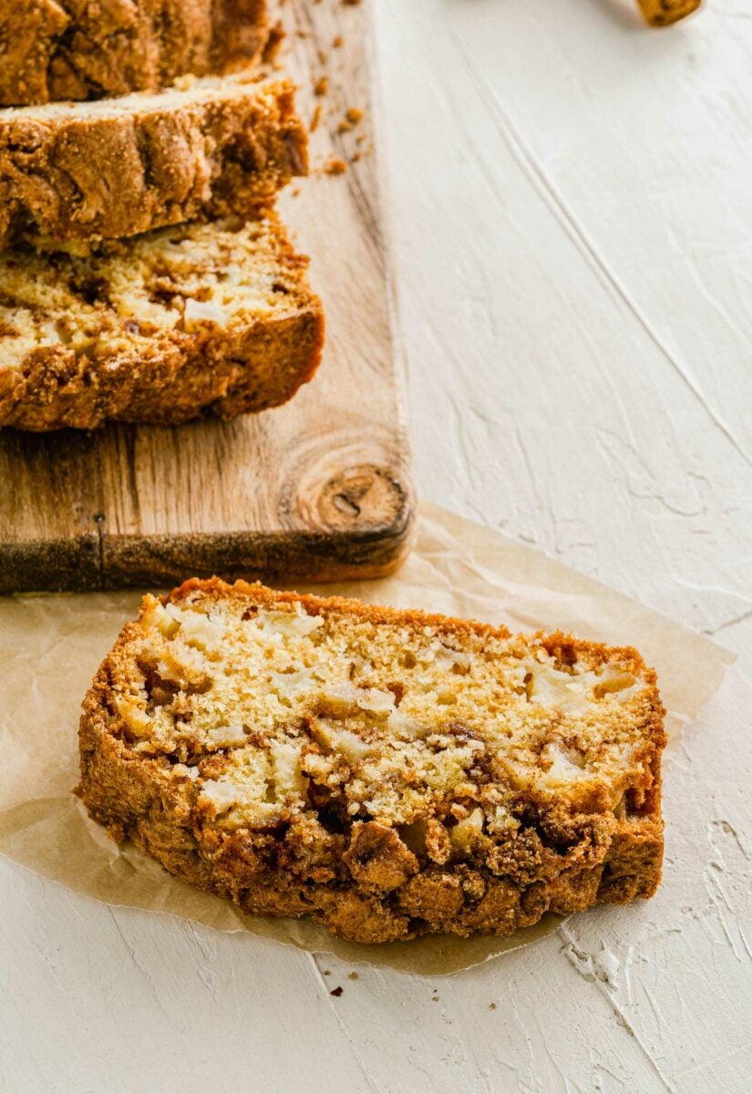 A slice of baked bread is presented on a white surface. 