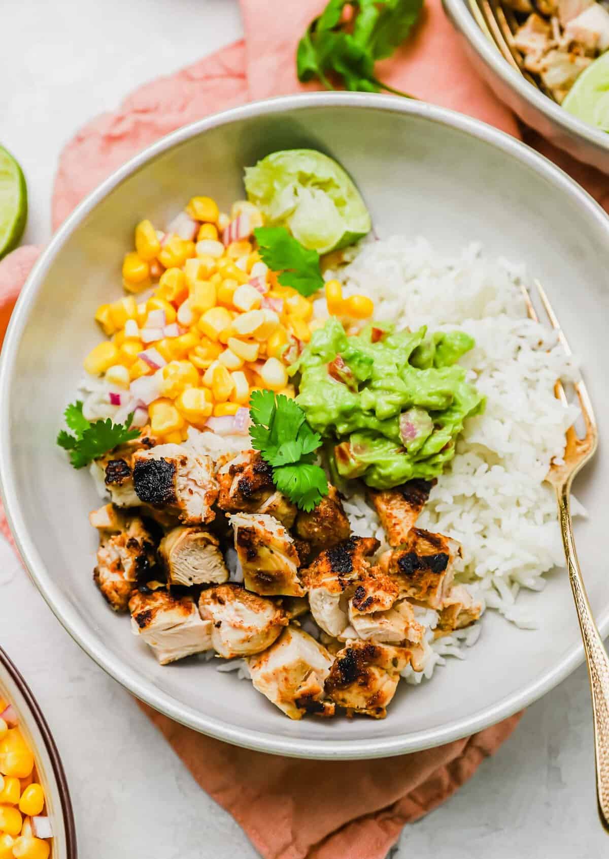 Overhead view of grilled chicken burrito bowl before garnishing with hot sauce