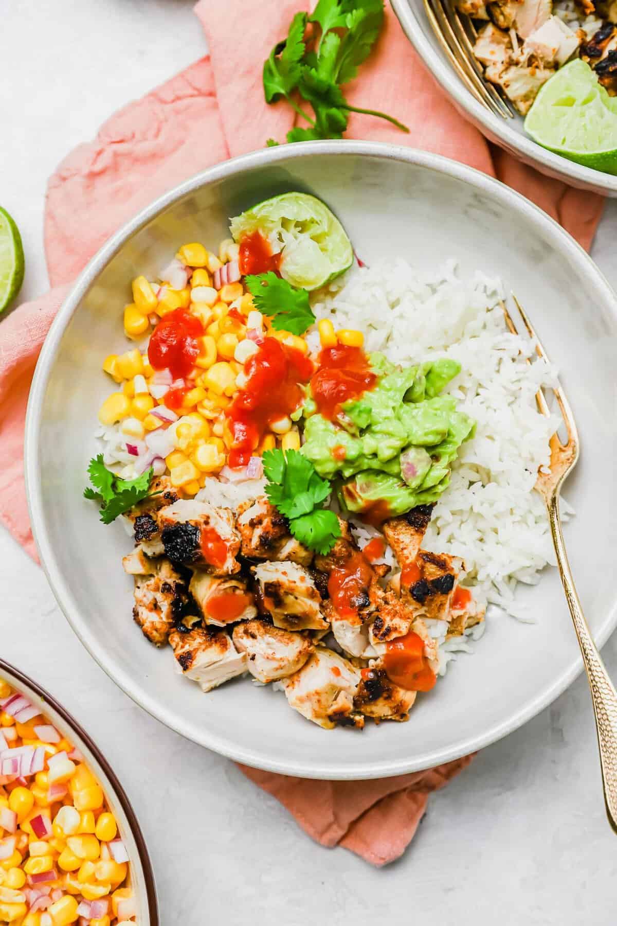 Overhead view of chicken burrito bowl with fork