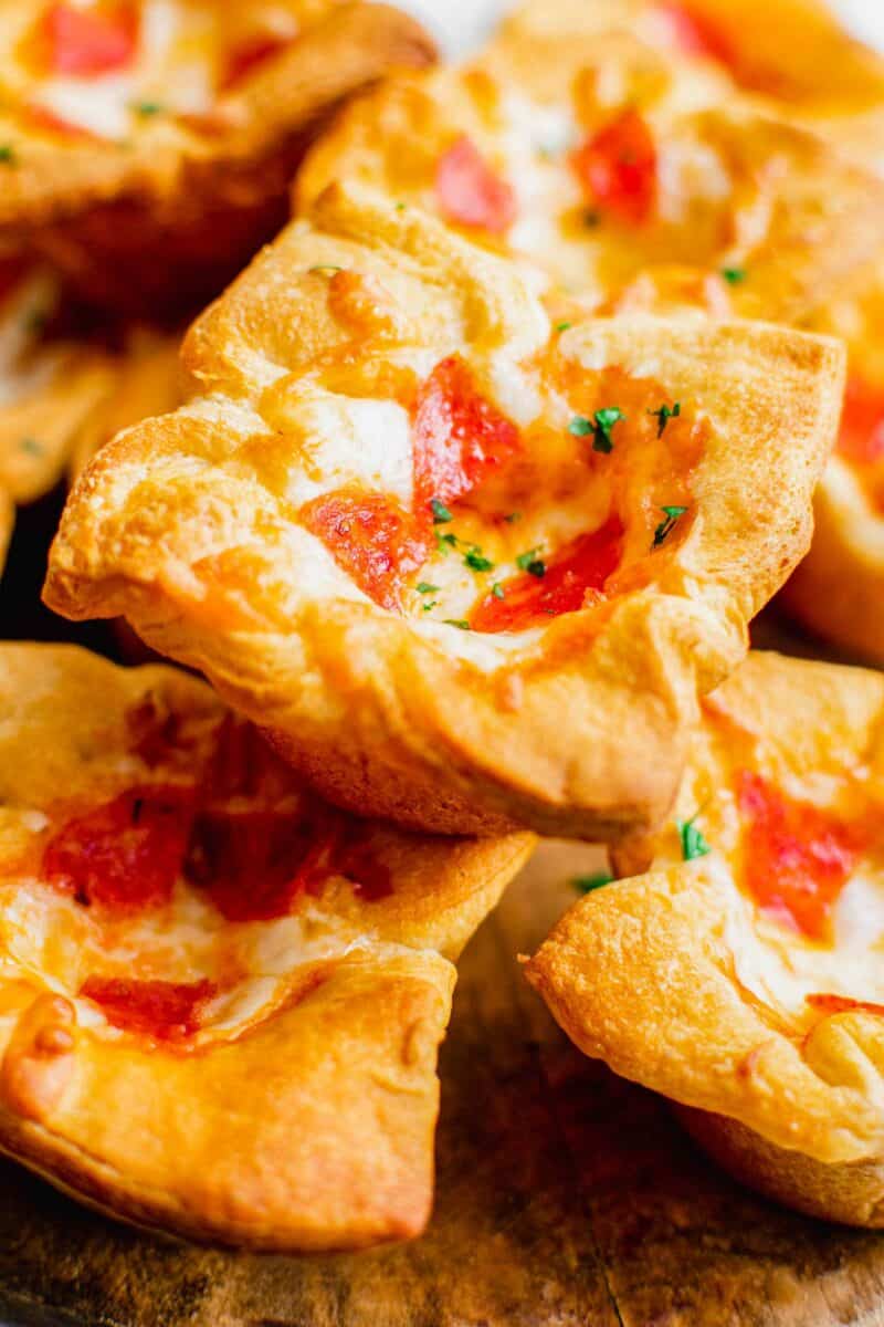 Perfectly baked pizza muffins are stacked on top of one another. 