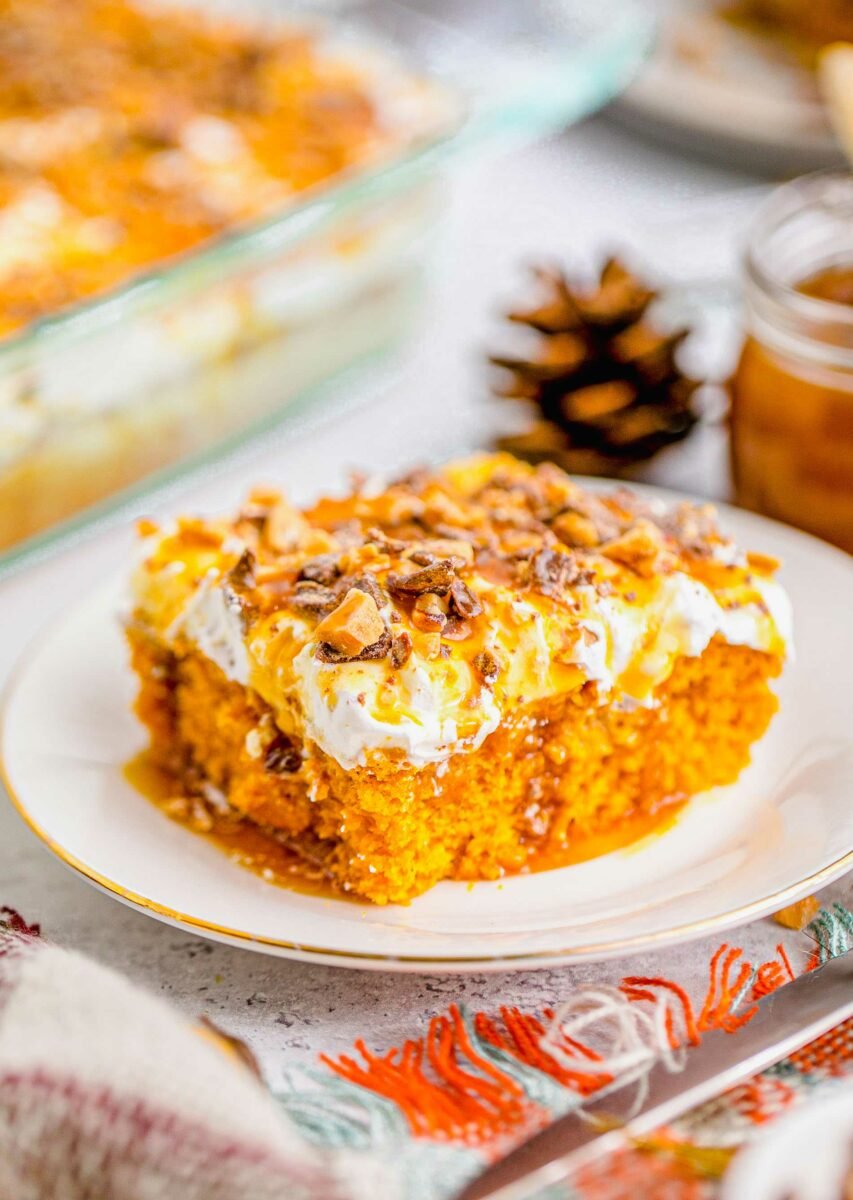 Pumpkin lush cake is drizzled with a hearty amount of caramel sauce. 