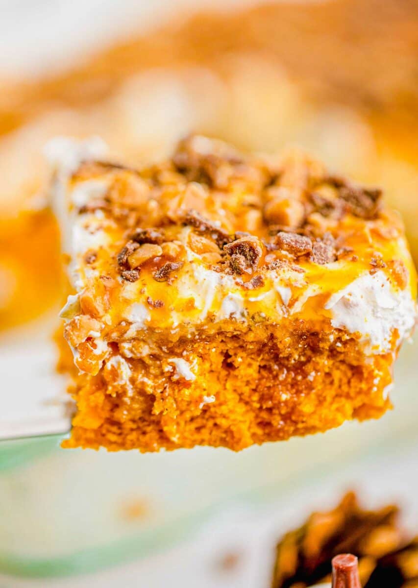 Pumpkin cake is topped with whipped cream caramel sauce and toffee bits. 