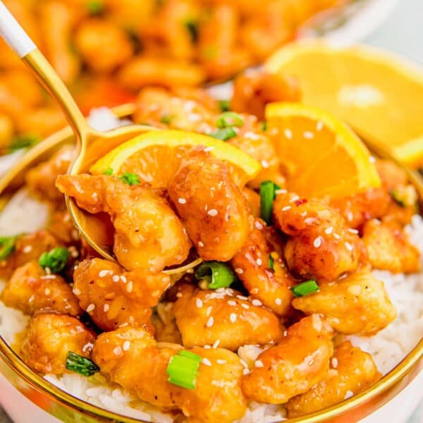 Taking a bite of orange chicken