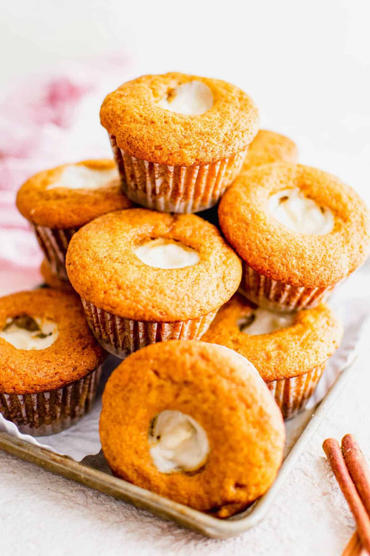 A stack of filled muffins is presented on a white surface. 