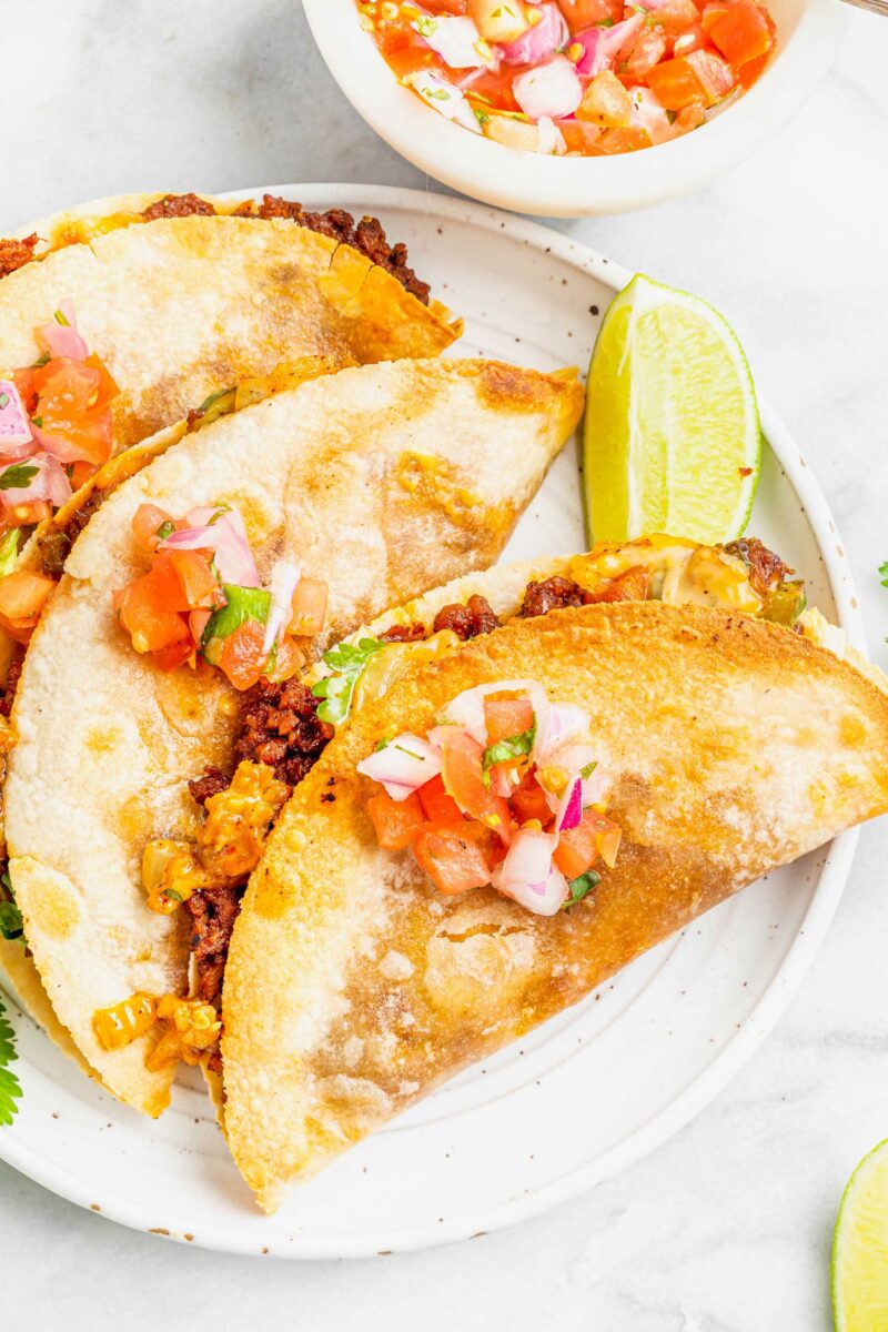 Pico de Gallo is placed on top of cooked quesadillas. 