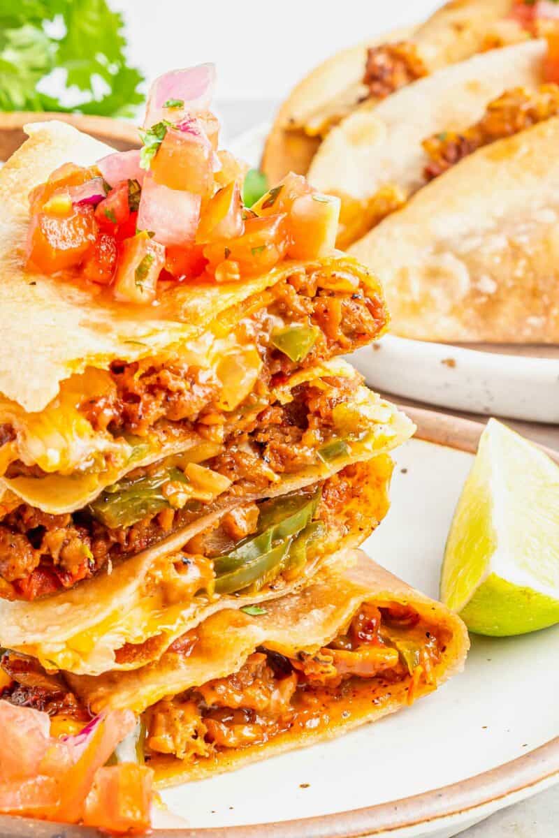 Several quesadillas are stacked on top of one another.