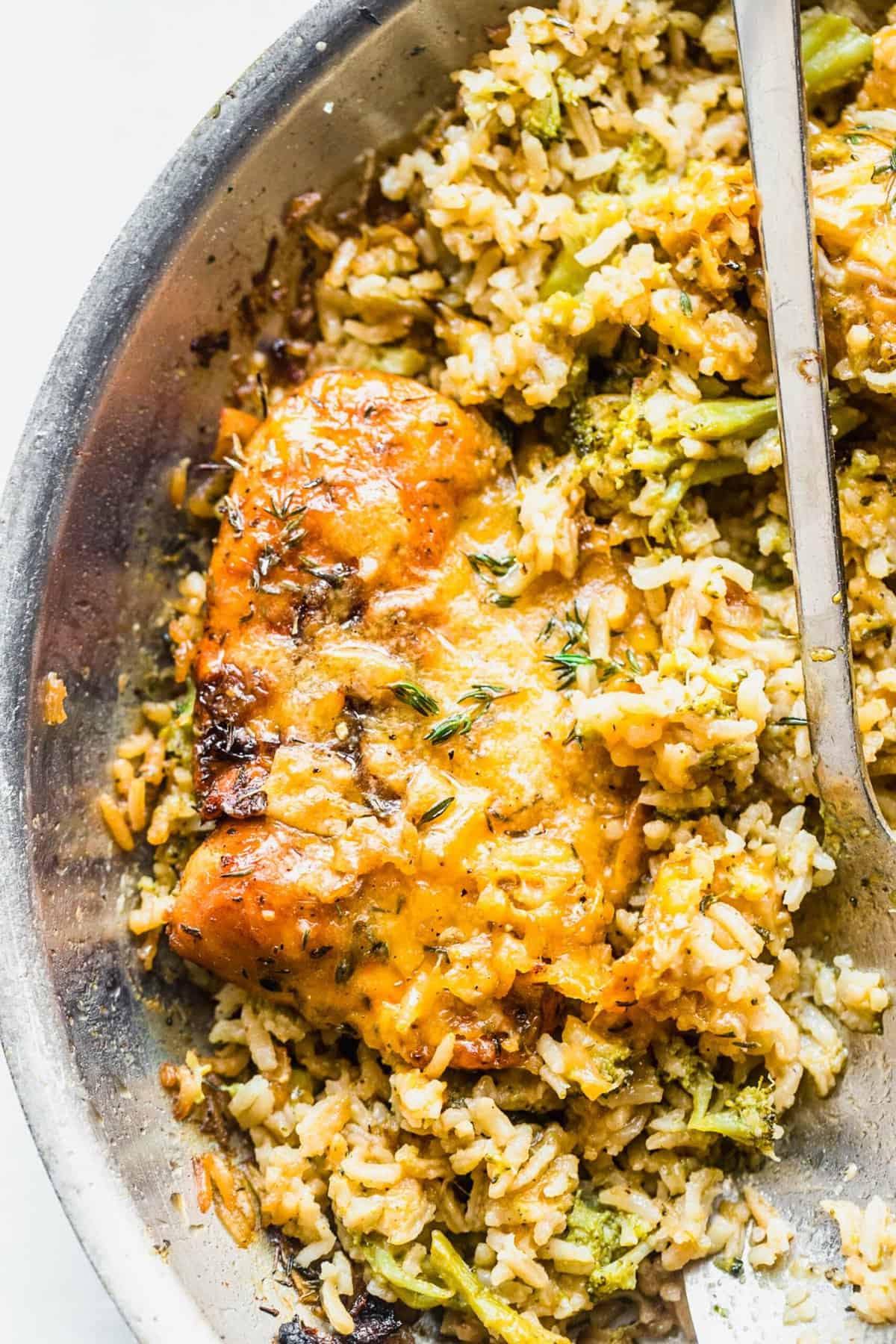 Cheesy Broccoli Rice Skillet in pan with spoon