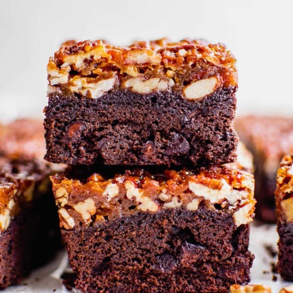 Several pecan pie brownies are stacked on top of one another.