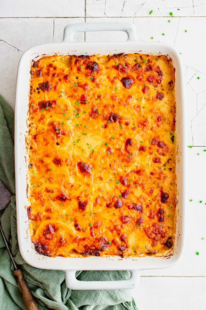 Chopped chives garnished a casserole dish filled with browned scalloped potatoes.