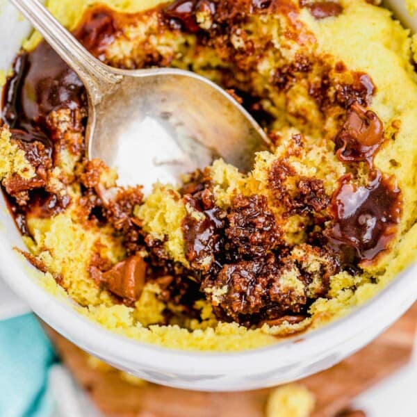 Spoon digging into chocolate chip mug cake