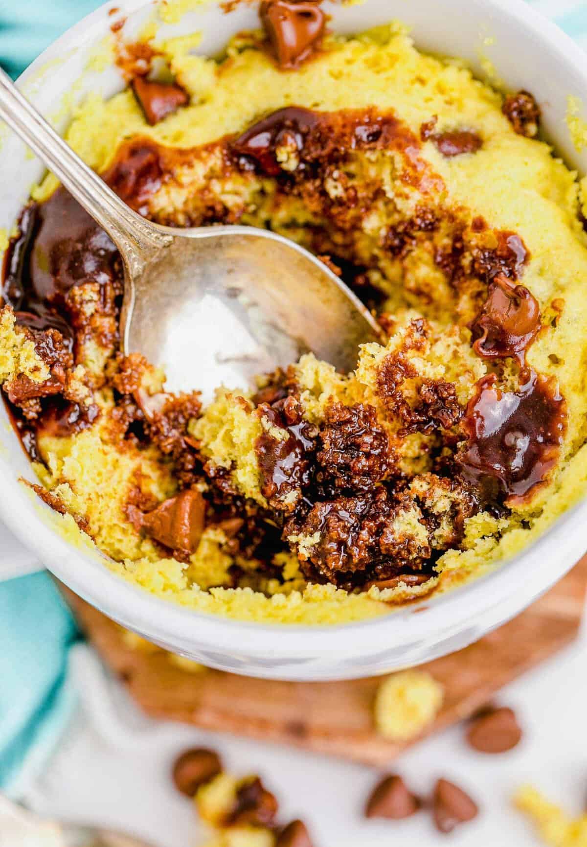 Spoon digging into chocolate chip mug cake