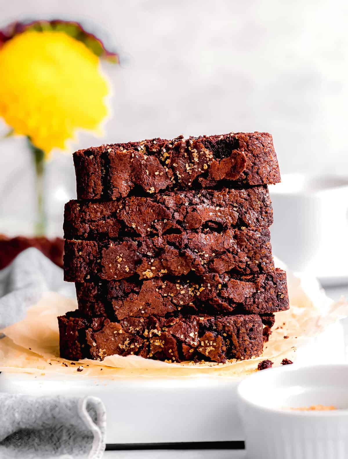 Stack of chocolate cinnamon bread slices on piece of parchment