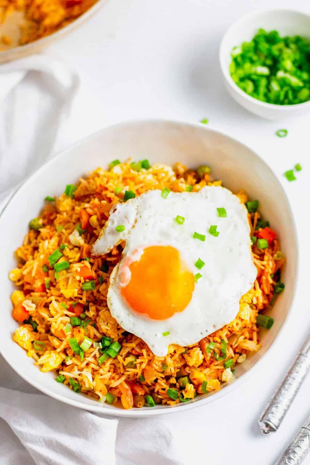 Kimchi fried rice topped with fried egg and garnished with green onions