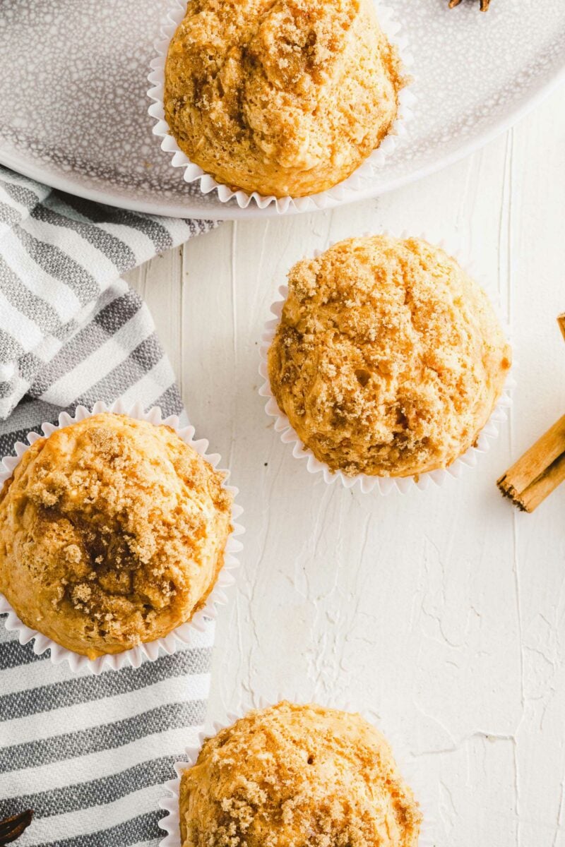 Several sweet potato muffins are presented on a white surface.