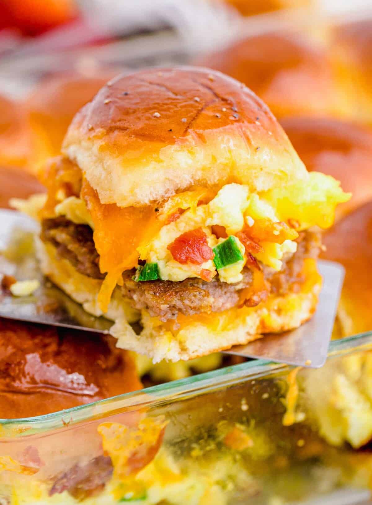 Breakfast slider being lifted out of baking dish