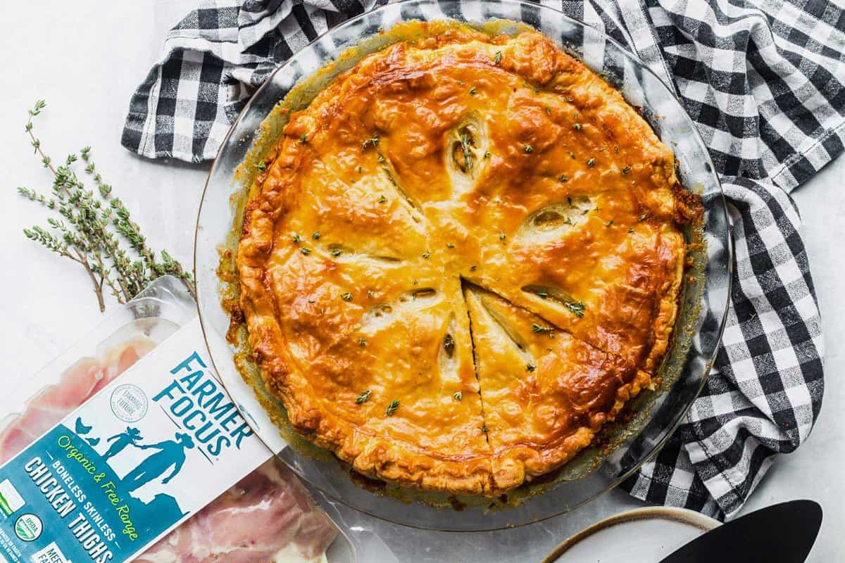 Overhead view of whole chicken broccoli pot pie in baking dish with Farmer Focus chicken thighs