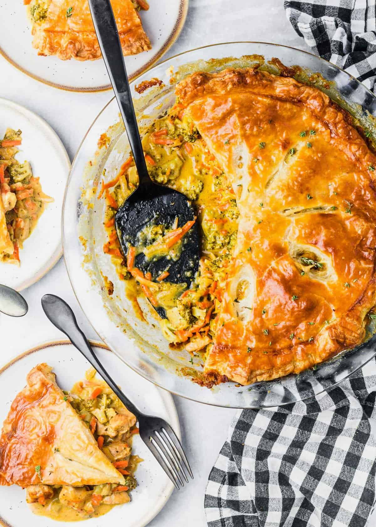 Overhead view of pot pie in baking dish with spoon after cutting