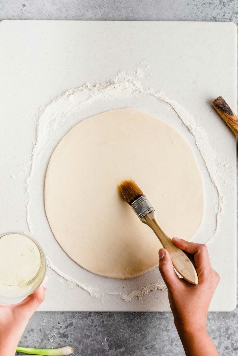 Brushing pancake dough with oil