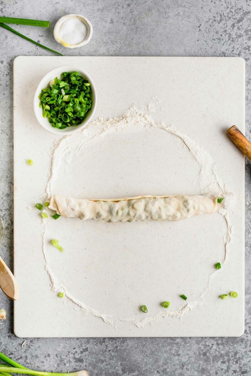 Overhead view of scallion pancake dough after rolling