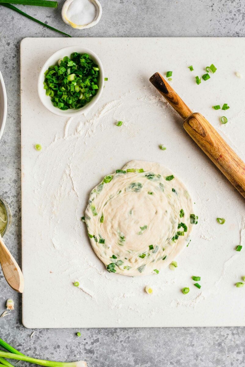 Overhead view of scallion pancake after rolling out