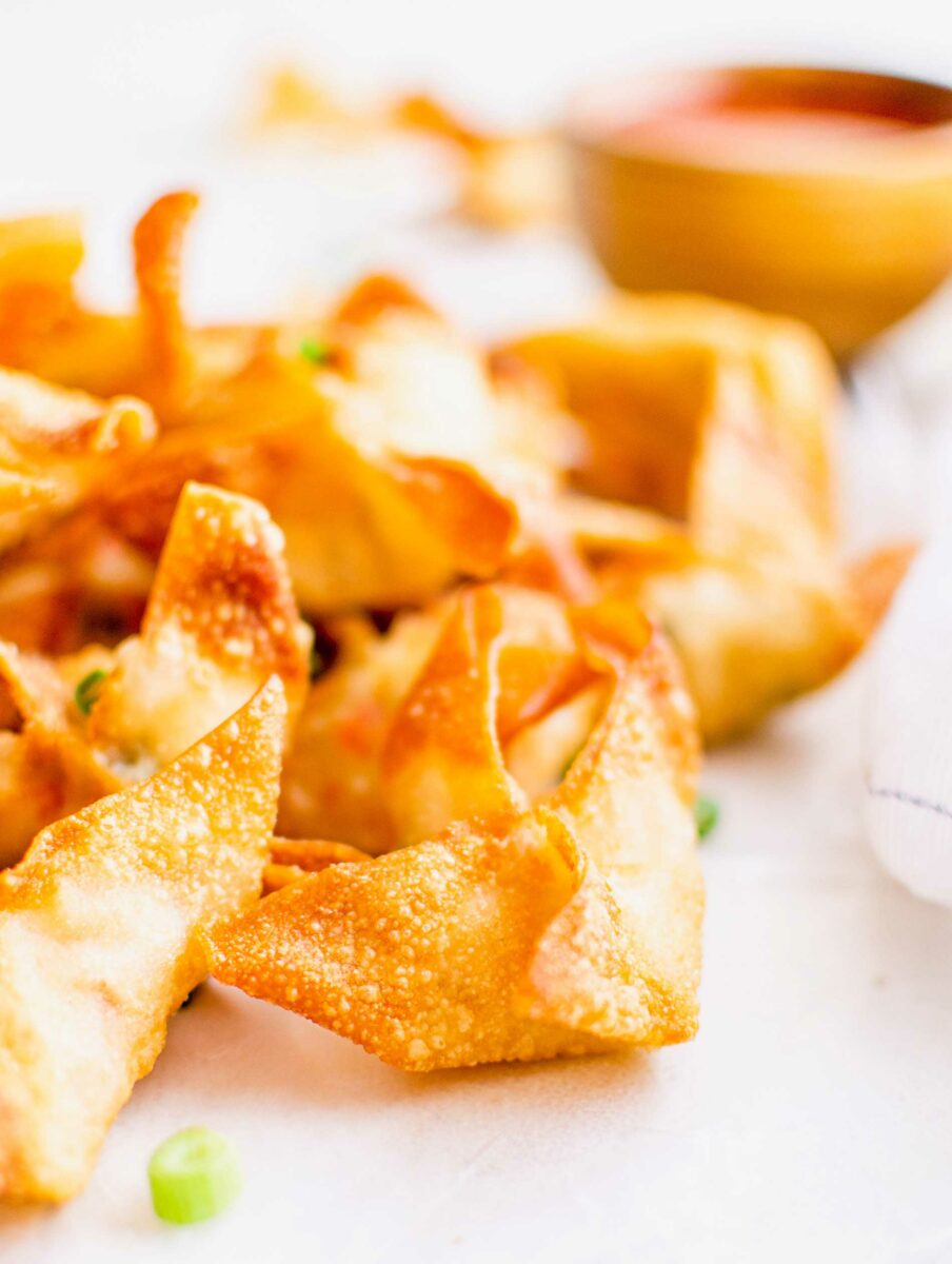 A close up image shows a golden brown fully cooked rangoon.