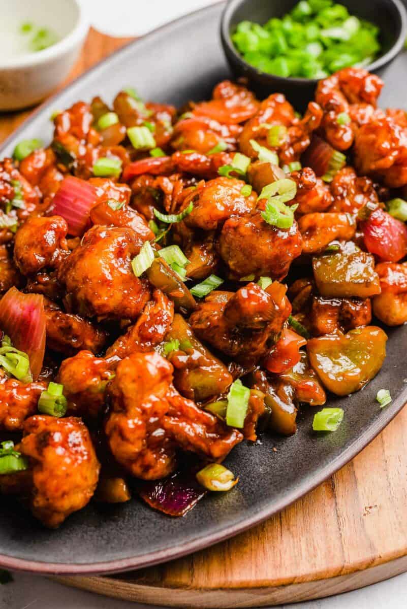 Gobi manchurian is topped with a handful of chopped scallions. 