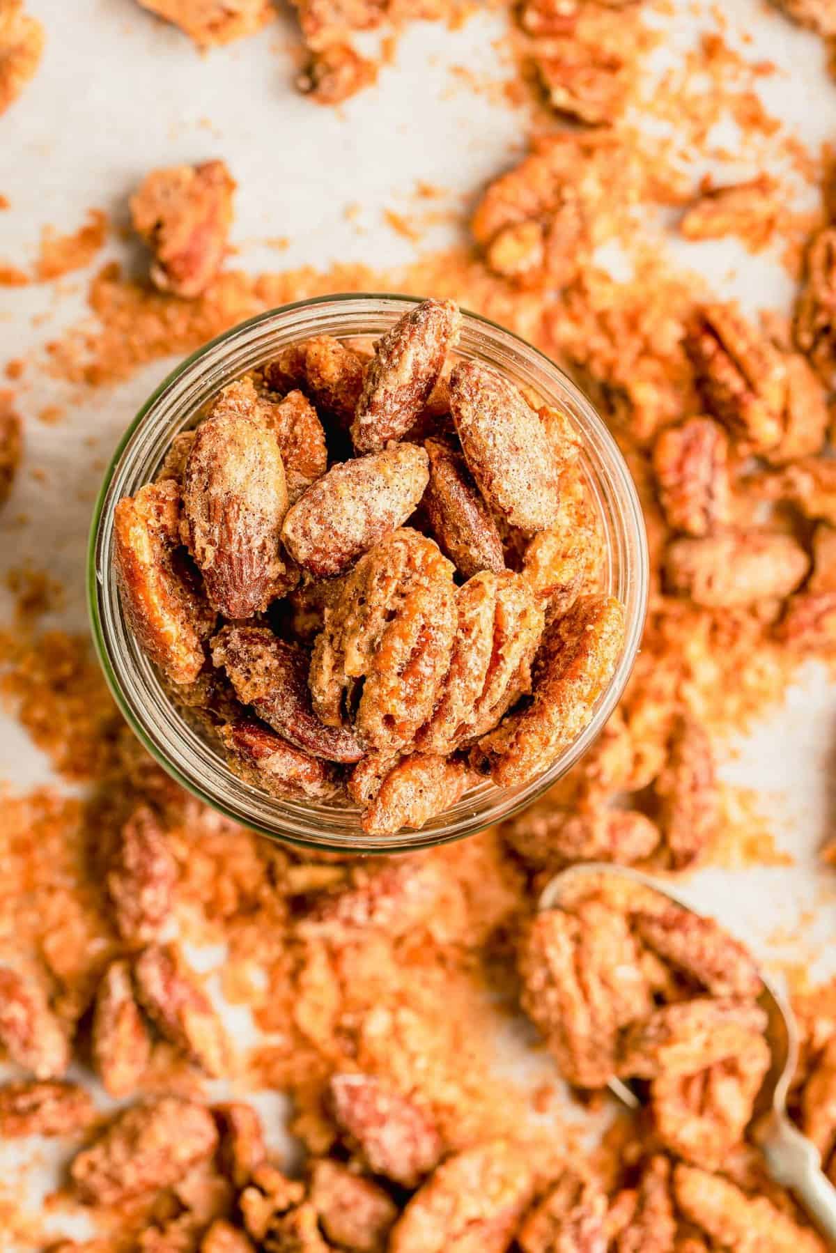 Overhead view of maple cinnamon spiced nuts in glass jar
