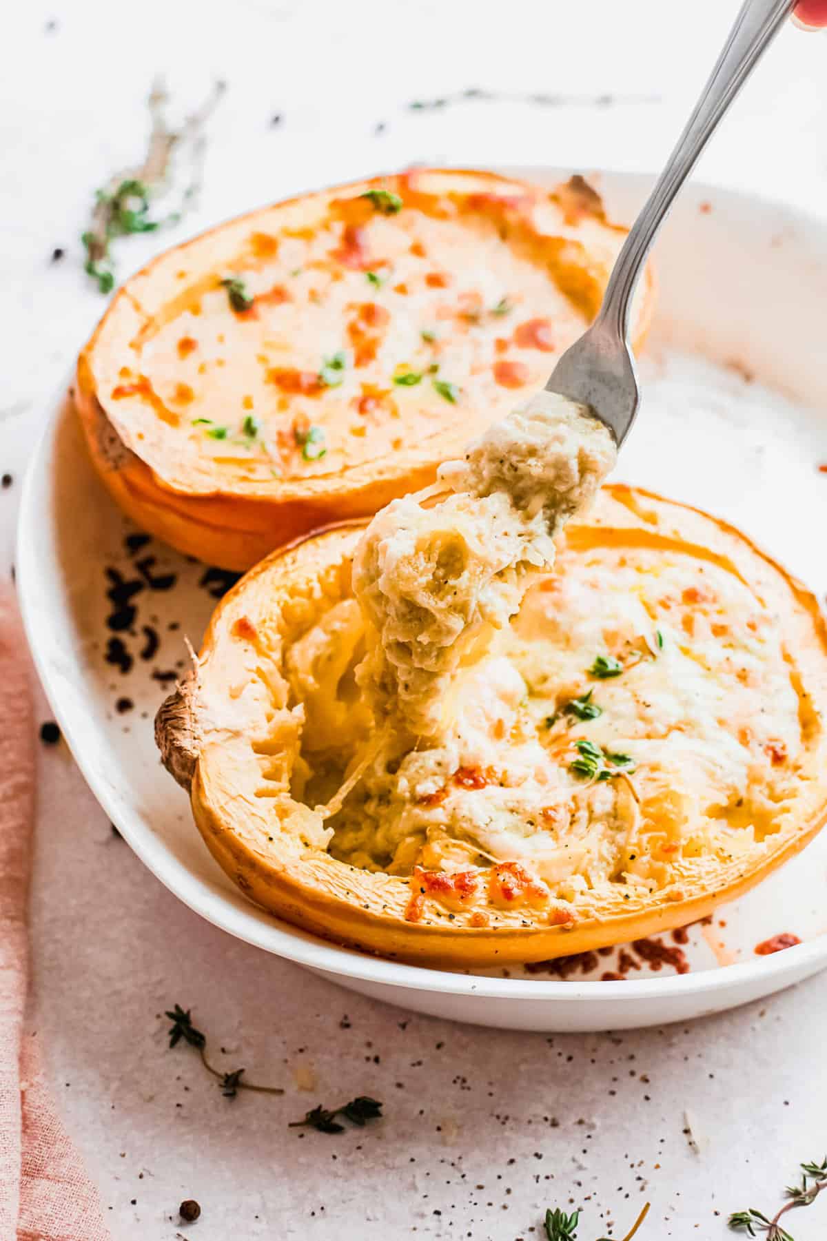 Lifting forkful of spaghetti squash from spaghetti squash boat