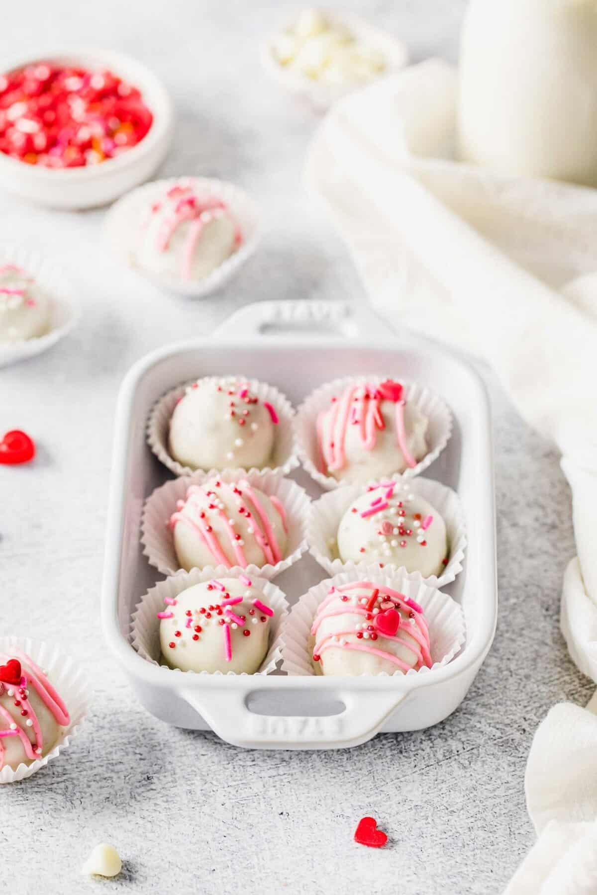 Six red velvet truffles decorated for Valentine's Day in small dish