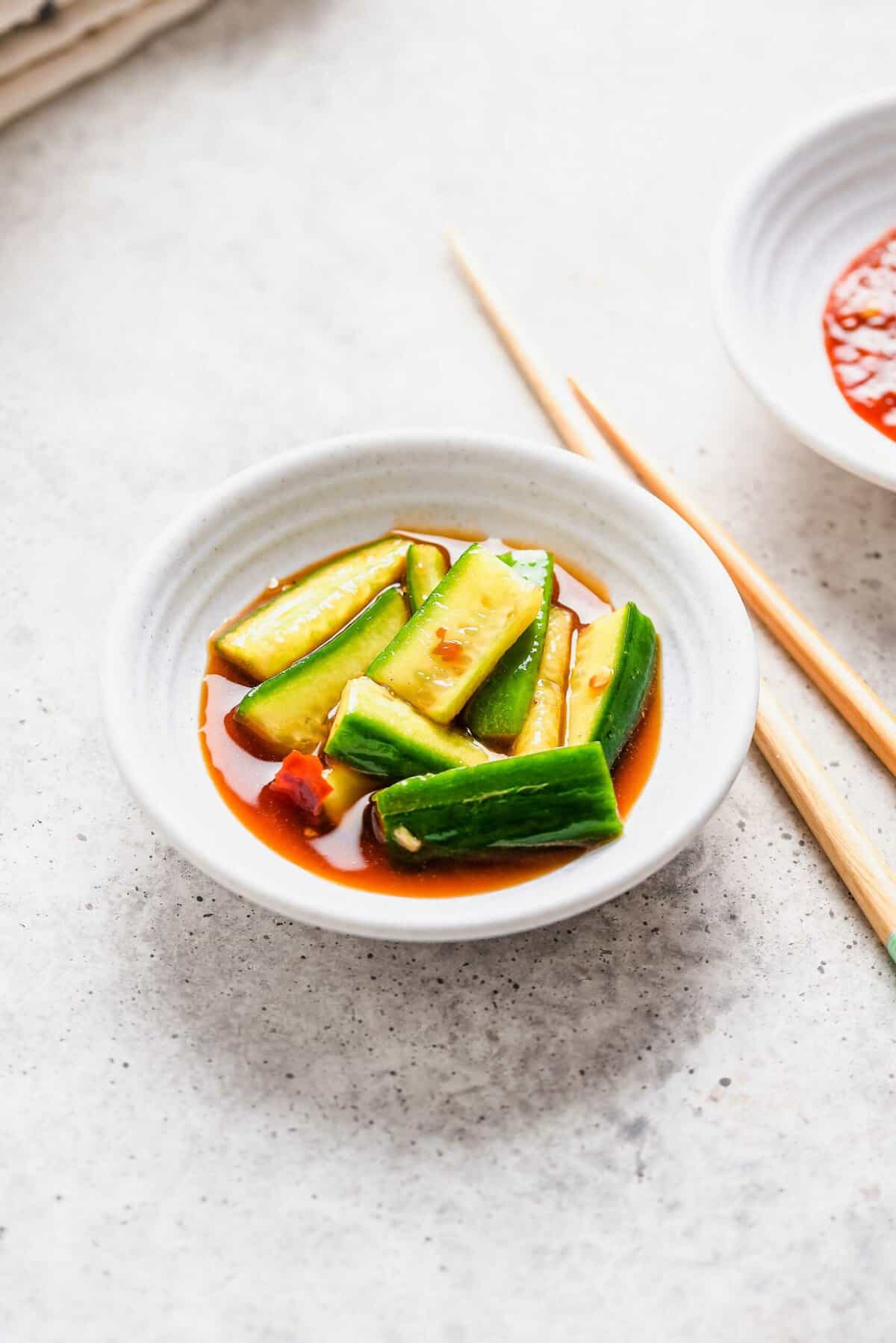 Small white bowl with spicy Chinese cucumber salad
