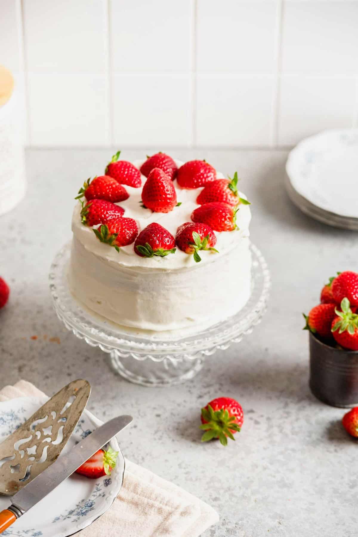 Strawberry sponge cake on glass cake stand