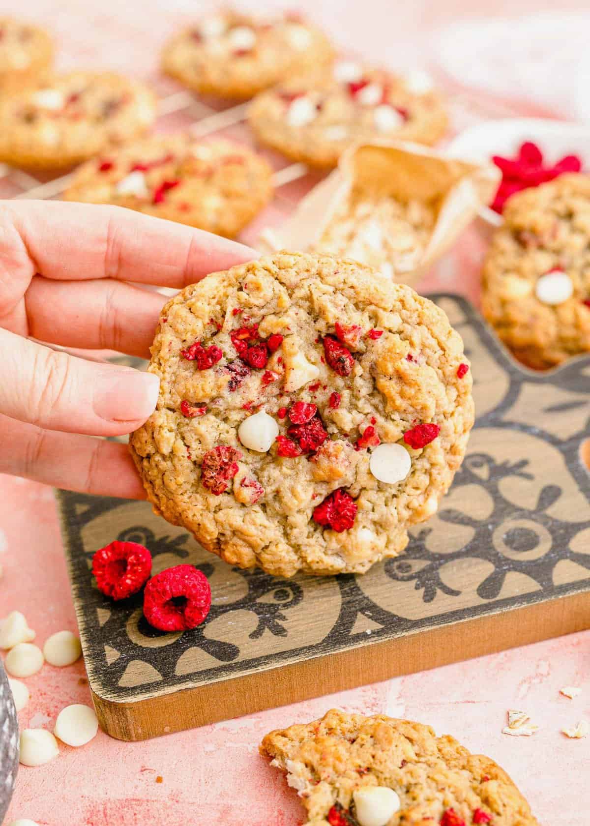 Hand holding a white chocolate raspberry cookie