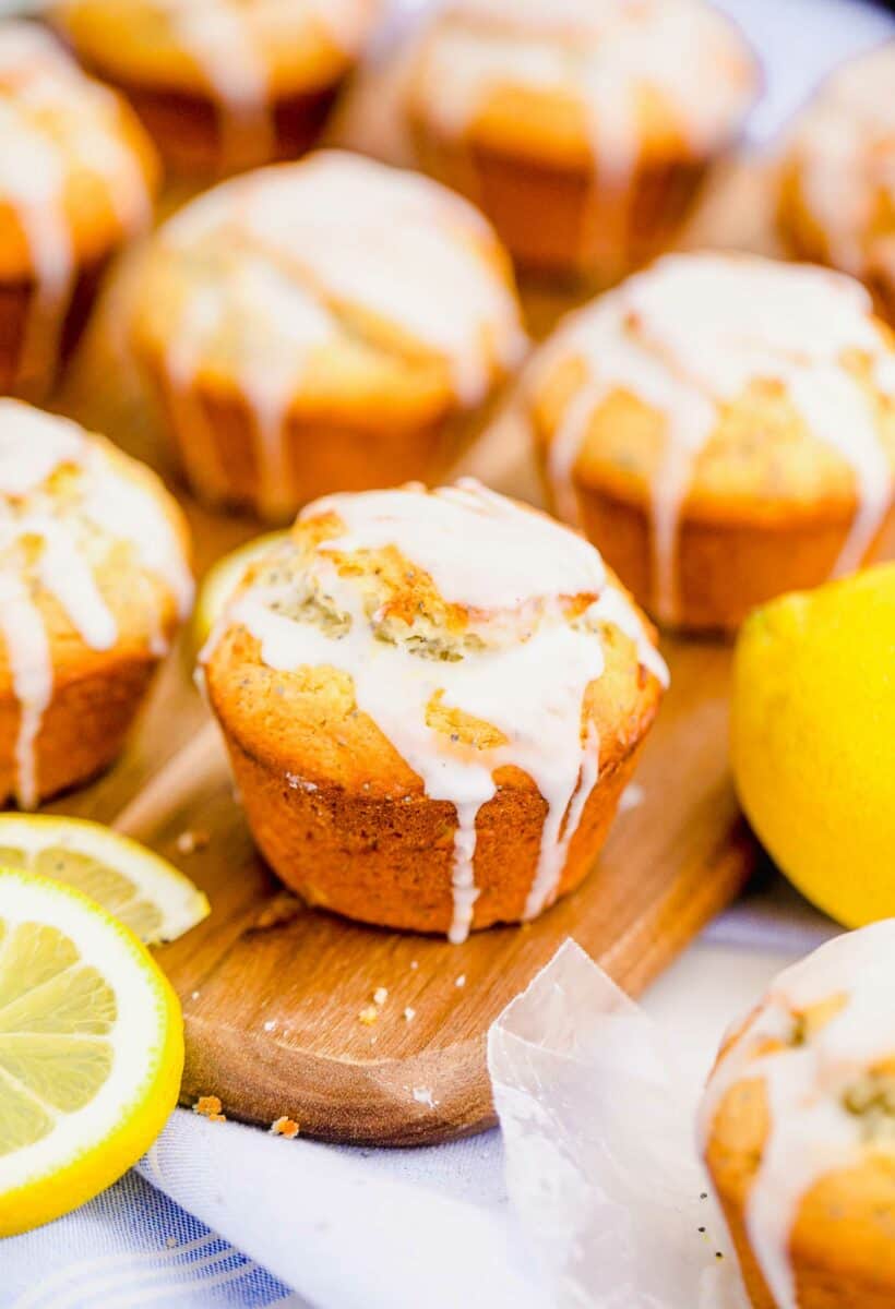 A baked lemon poppyseed muffin has been topped with homemade white glaze. 
